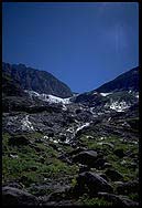 Glacier melt cascades down mountain hill